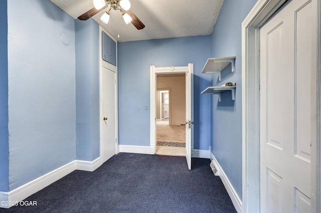 117 S 11th St, Sarcoxie, MO 64862 - unfurnished bedroom with dark carpet, a textured ceiling, and a ceiling fan