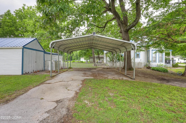 117 S 11th St, Sarcoxie, MO 64862 - view of car parking with asphalt driveway, a storage shed, and a carport