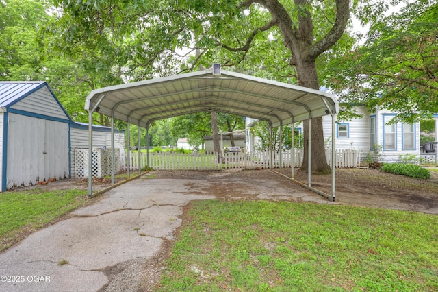 117 S 11th St, Sarcoxie, MO 64862 - view of vehicle parking featuring asphalt driveway, a storage shed, and a detached carport