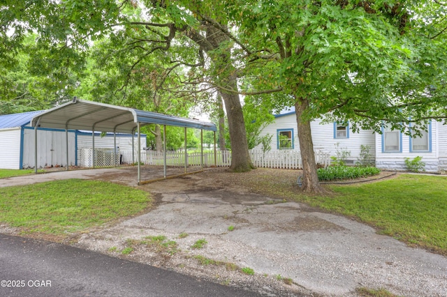 117 S 11th St, Sarcoxie, MO 64862 - view of car parking with asphalt driveway and a carport