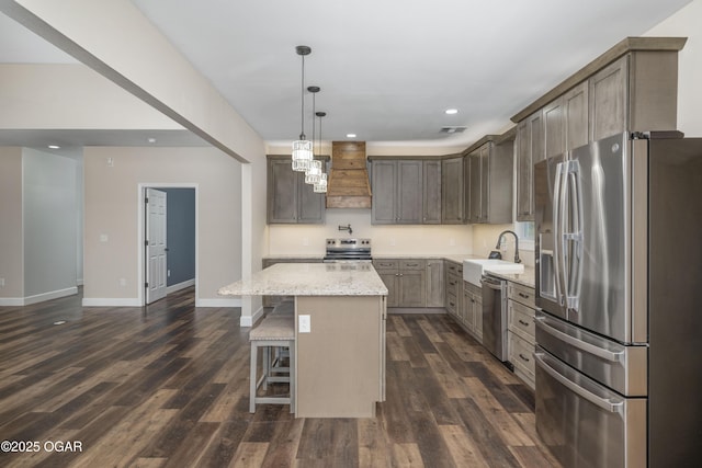 4610 W Amber Rd, Joplin, MO 64804 - kitchen with appliances with stainless steel finishes, recessed lighting, a kitchen island, dark wood-style flooring, and light stone countertops