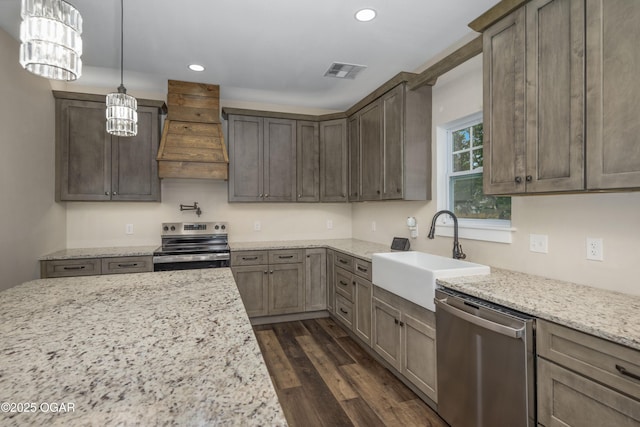 4610 W Amber Rd, Joplin, MO 64804 - kitchen featuring appliances with stainless steel finishes, custom exhaust hood, dark wood finished floors, light stone counters, and recessed lighting