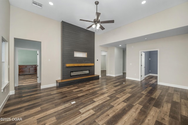 4610 W Amber Rd, Joplin, MO 64804 - unfurnished living room featuring a ceiling fan, wood finished floors, a fireplace, and recessed lighting