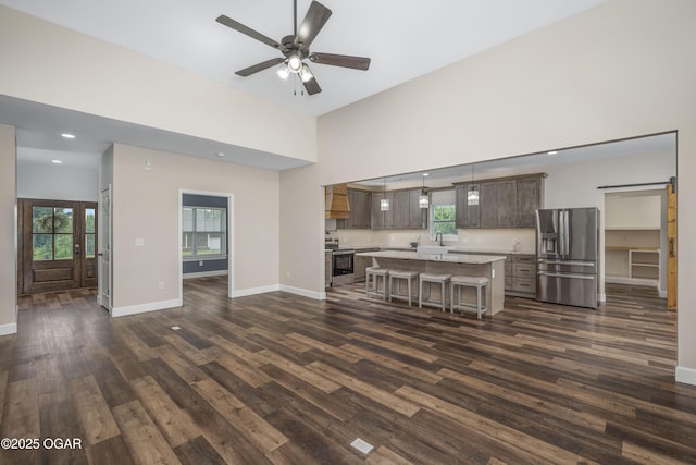 4610 W Amber Rd, Joplin, MO 64804 - living area with dark wood-style floors, healthy amount of natural light, a ceiling fan, recessed lighting, and a high ceiling