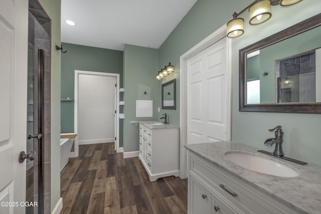 4610 W Amber Rd, Joplin, MO 64804 - full bath with wood finished floors, a soaking tub, two vanities, a tile shower, and recessed lighting