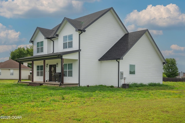 4610 W Amber Rd, Joplin, MO 64804 - rear view of property featuring a porch, a yard, and a shingled roof