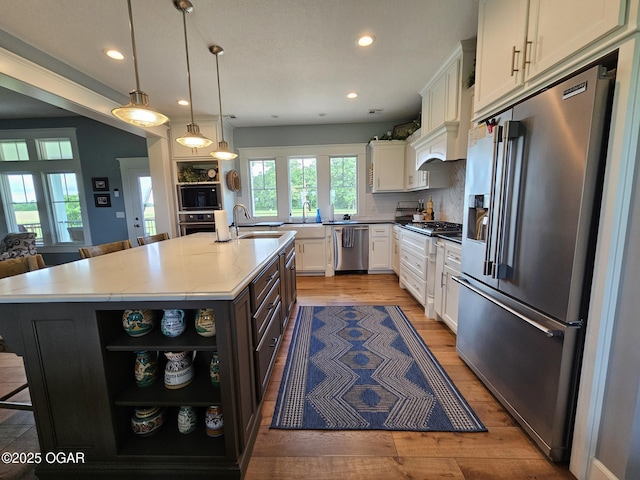 12673 Ibex Rd, Neosho, MO 64850 - kitchen with stainless steel appliances, open shelves, white cabinets, recessed lighting, and light wood finished floors