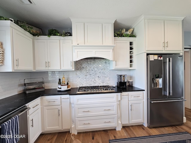 12673 Ibex Rd, Neosho, MO 64850 - kitchen with appliances with stainless steel finishes, white cabinets, and wood finished floors