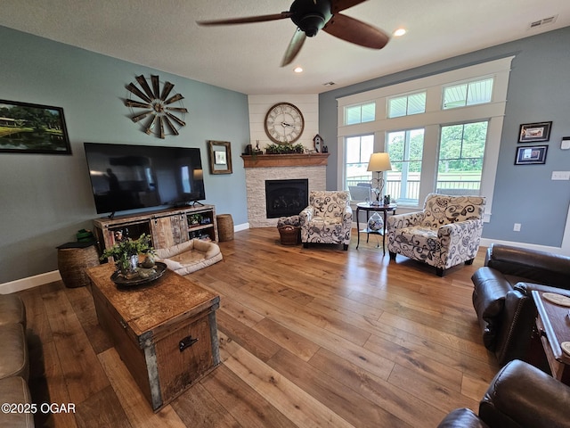 12673 Ibex Rd, Neosho, MO 64850 - living area featuring ceiling fan, a fireplace, hardwood / wood-style flooring, and recessed lighting