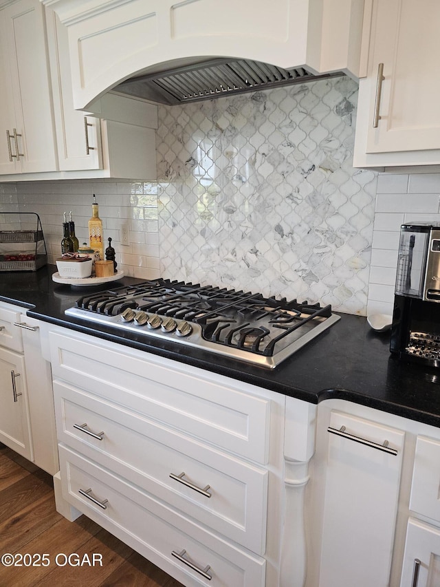12673 Ibex Rd, Neosho, MO 64850 - kitchen with stainless steel gas stovetop, premium range hood, white cabinets, and backsplash