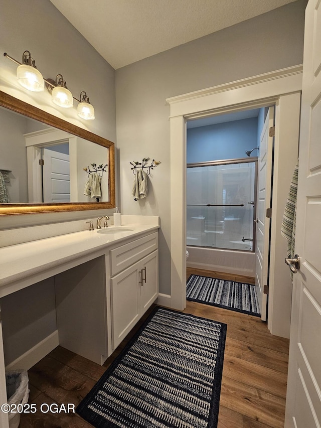 12673 Ibex Rd, Neosho, MO 64850 - full bath featuring wood finished floors, vanity, and combined bath / shower with glass door
