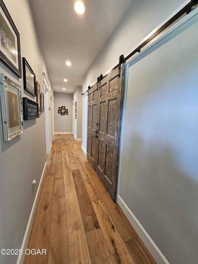 12673 Ibex Rd, Neosho, MO 64850 - hall with a barn door, wood-type flooring, and recessed lighting