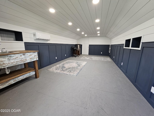12673 Ibex Rd, Neosho, MO 64850 - misc room with vaulted ceiling, an AC wall unit, recessed lighting, and a decorative wall