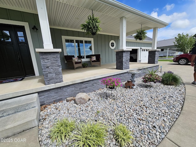 12673 Ibex Rd, Neosho, MO 64850 - entrance to property with a porch, board and batten siding, and stone siding