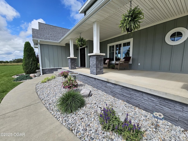 12673 Ibex Rd, Neosho, MO 64850 - view of exterior entry with board and batten siding and a shingled roof