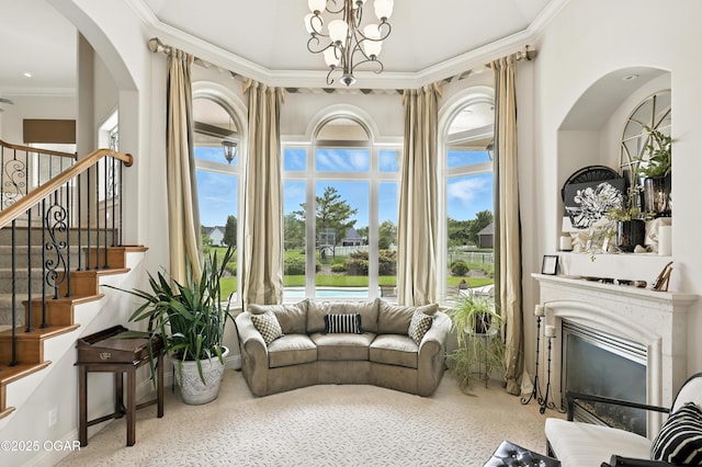 1641 Alexandra Dr, Carthage, MO 64836 - living room featuring speckle patterned floor, ornamental molding, stairway, a chandelier, and a glass covered fireplace