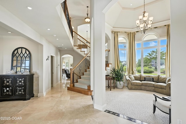 1641 Alexandra Dr, Carthage, MO 64836 - entrance foyer featuring arched walkways, stairway, crown molding, a towering ceiling, and recessed lighting