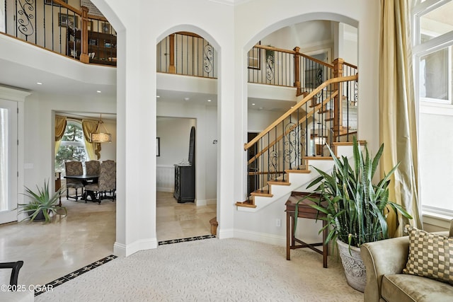 1641 Alexandra Dr, Carthage, MO 64836 - staircase with inlaid floor details and a towering ceiling