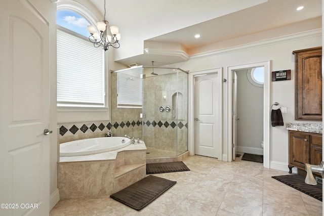 1641 Alexandra Dr, Carthage, MO 64836 - bathroom featuring a bath, a shower stall, vanity, a chandelier, and tile patterned flooring