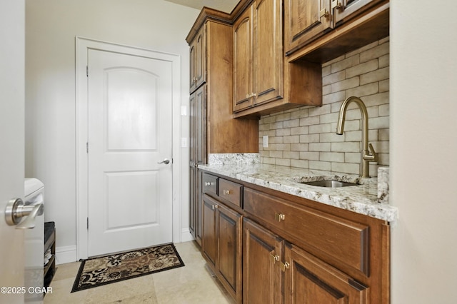 1641 Alexandra Dr, Carthage, MO 64836 - kitchen featuring tasteful backsplash, light stone countertops, and brown cabinets