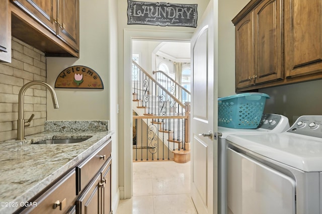 1641 Alexandra Dr, Carthage, MO 64836 - laundry room with cabinet space, washer and dryer, and light tile patterned flooring