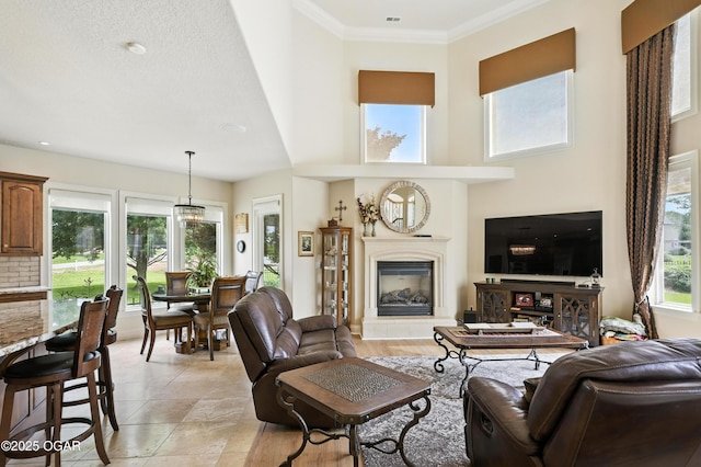 1641 Alexandra Dr, Carthage, MO 64836 - living area featuring a glass covered fireplace, a high ceiling, light tile patterned floors, and ornamental molding