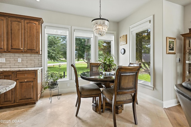 1641 Alexandra Dr, Carthage, MO 64836 - dining space featuring a chandelier, plenty of natural light, and light tile patterned flooring