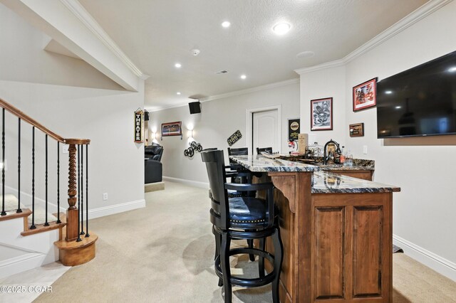1641 Alexandra Dr, Carthage, MO 64836 - indoor wet bar featuring light colored carpet, stairway, ornamental molding, and recessed lighting