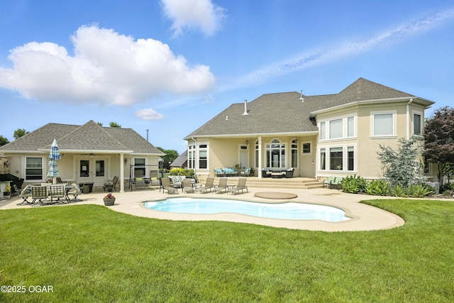 1641 Alexandra Dr, Carthage, MO 64836 - rear view of house with a patio area, a lawn, an outdoor pool, stucco siding, and french doors