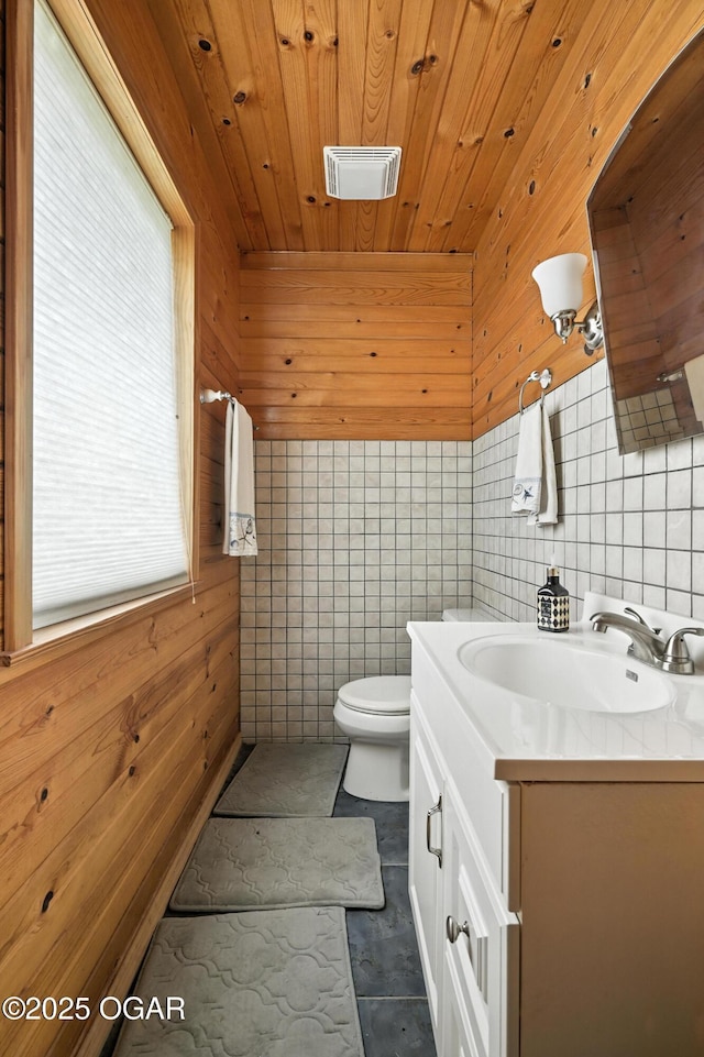 1641 Alexandra Dr, Carthage, MO 64836 - bathroom with vanity, wood ceiling, wood walls, tile walls, and tile patterned floors