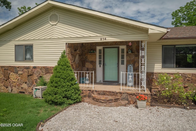 214 S Ozark Trl, Goodman, MO 64843 - entrance to property with stone siding and a porch