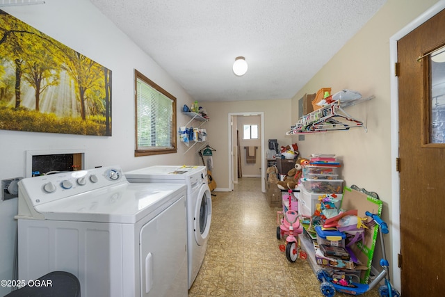 214 S Ozark Trl, Goodman, MO 64843 - laundry room with washing machine and clothes dryer, light floors, and a textured ceiling