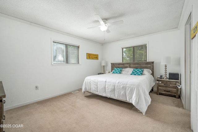 214 S Ozark Trl, Goodman, MO 64843 - bedroom featuring light carpet, a textured ceiling, and a ceiling fan
