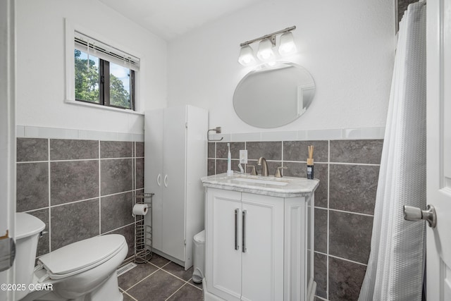 214 S Ozark Trl, Goodman, MO 64843 - full bath with tile walls, vanity, tile patterned floors, and wainscoting