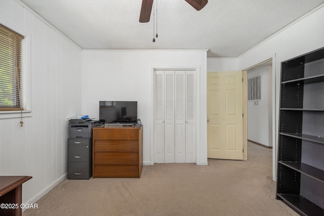 214 S Ozark Trl, Goodman, MO 64843 - bedroom featuring carpet floors, a closet, a textured ceiling, and ceiling fan