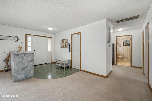 214 S Ozark Trl, Goodman, MO 64843 - carpeted entryway with a textured ceiling and baseboards