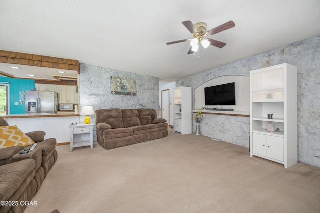 214 S Ozark Trl, Goodman, MO 64843 - living area with light colored carpet, ceiling fan, and wallpapered walls