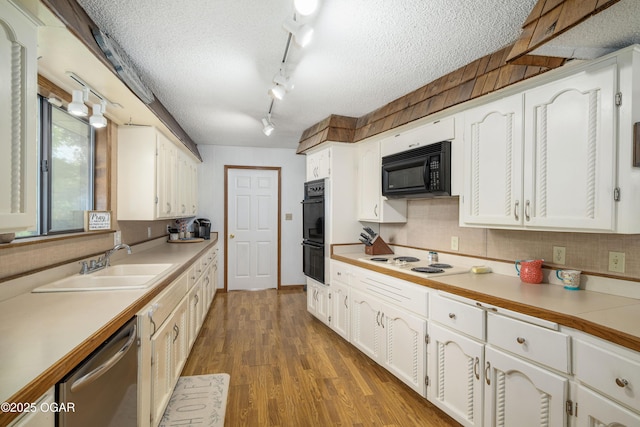 214 S Ozark Trl, Goodman, MO 64843 - kitchen featuring black appliances, white cabinets, a textured ceiling, wood finished floors, and tasteful backsplash