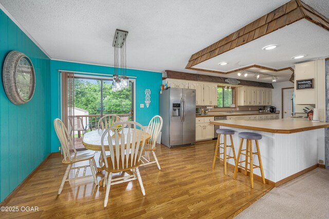 214 S Ozark Trl, Goodman, MO 64843 - dining space with light wood finished floors and a textured ceiling