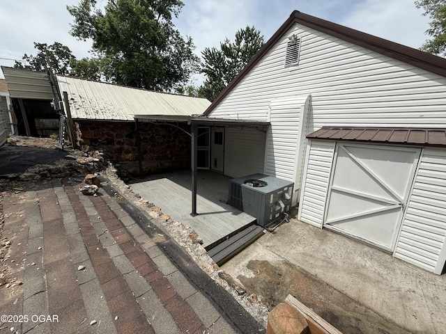 1310 Regan Ave, Carthage, MO 64836 - view of side of home featuring a metal roof and a patio