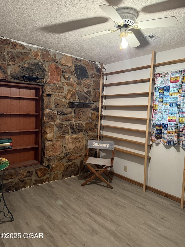 1310 Regan Ave, Carthage, MO 64836 - unfurnished room with wood finished floors, a textured ceiling, and a ceiling fan