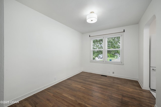 424 S Mcconnell Ave, Joplin, MO 64801 - empty room with arched walkways and dark wood-style flooring