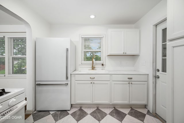 424 S Mcconnell Ave, Joplin, MO 64801 - kitchen with freestanding refrigerator, white cabinetry, light countertops, range, and recessed lighting