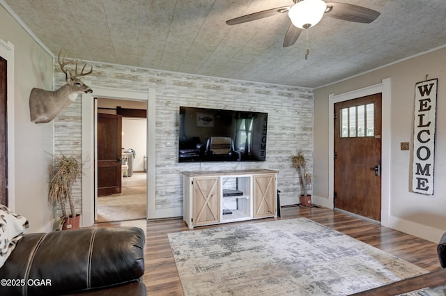7614 Apple, Sarcoxie, MO 64862 - living area featuring a barn door, wood finished floors, ceiling fan, and ornamental molding