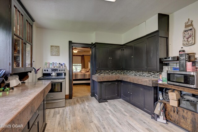 7614 Apple, Sarcoxie, MO 64862 - kitchen featuring appliances with stainless steel finishes, light wood finished floors, and backsplash