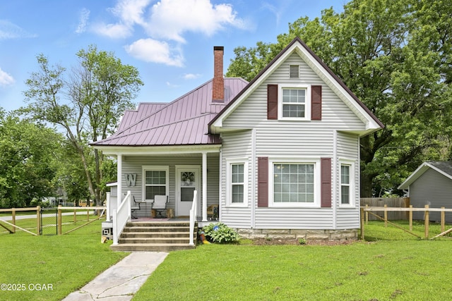 301 N 1st St, Jasper, MO 64755 - view of front facade with covered porch, a chimney, and a metal roof