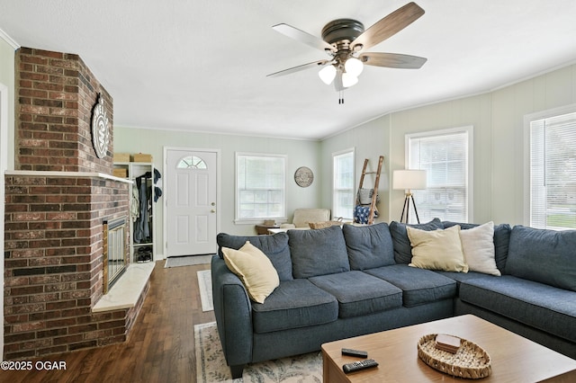 301 N 1st St, Jasper, MO 64755 - living area with wood-type flooring, crown molding, a ceiling fan, and a fireplace
