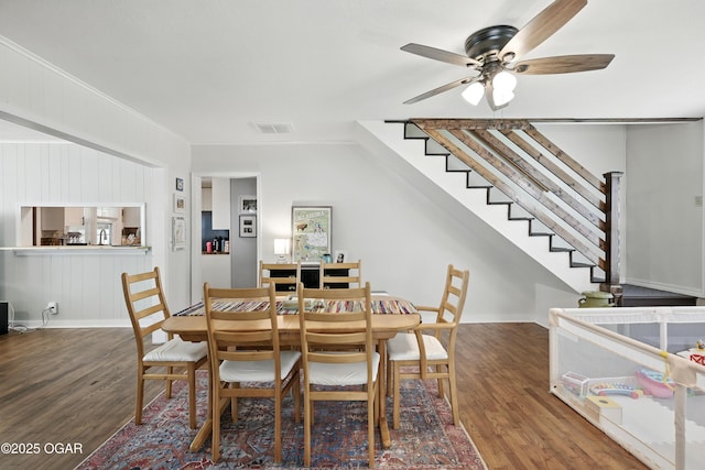 301 N 1st St, Jasper, MO 64755 - dining room featuring wood finished floors, ceiling fan, stairway, and ornamental molding