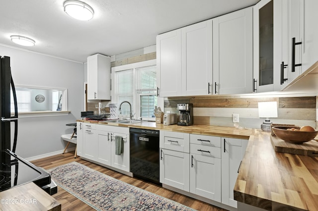 301 N 1st St, Jasper, MO 64755 - kitchen featuring black appliances, butcher block countertops, white cabinets, light wood-style floors, and ornamental molding