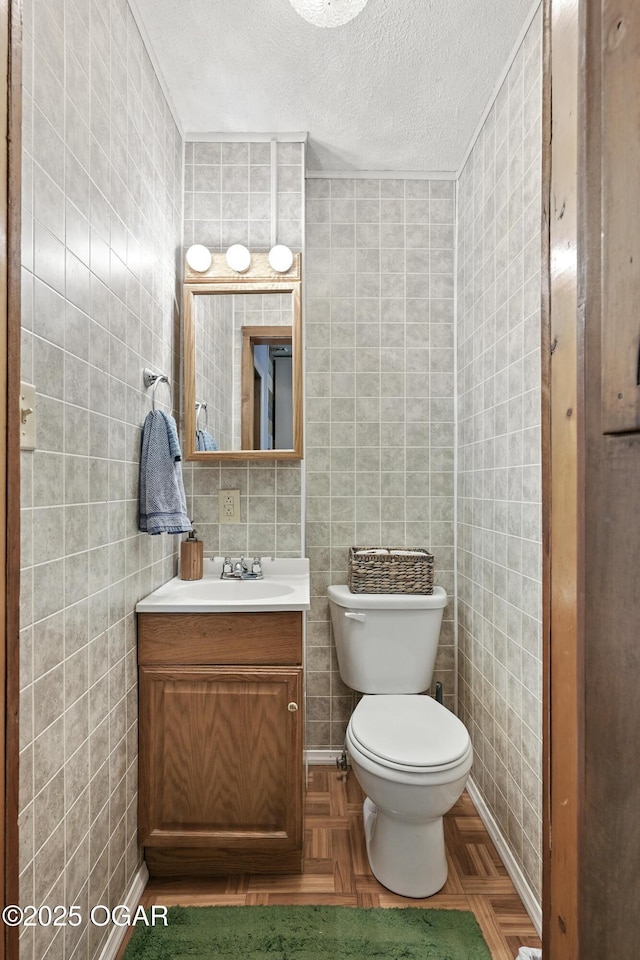 301 N 1st St, Jasper, MO 64755 - half bathroom with vanity, a textured ceiling, and tile walls
